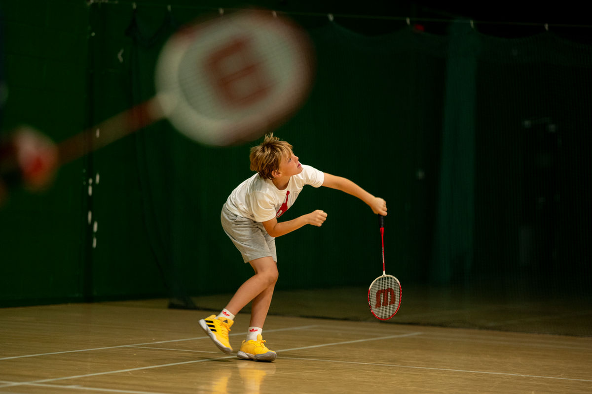 Young badminton player practising on court at Parklangley