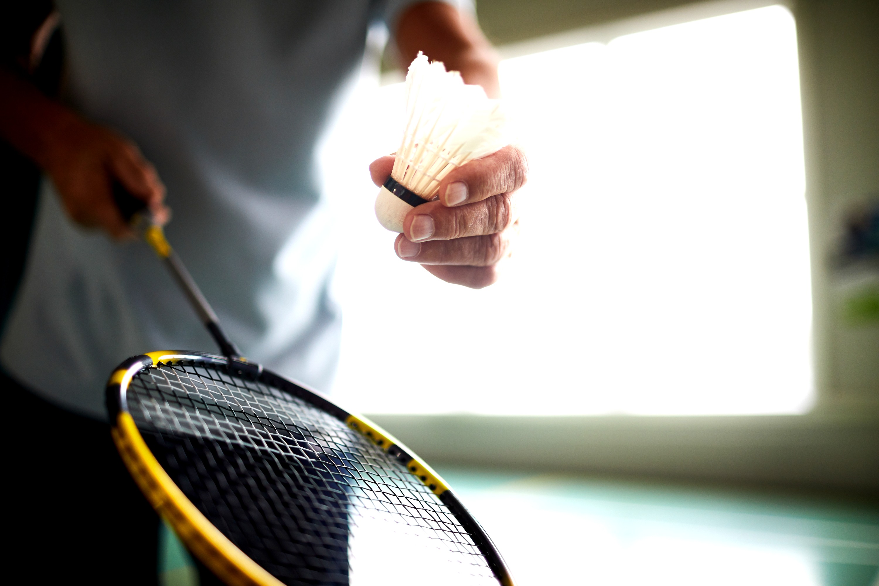 A racket and shuttle ready for a serve